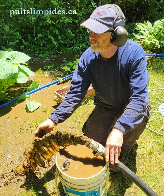 Guy Gosselin lors de l'évacuation de l'eau de curage d'un puits avec eau ferreuse